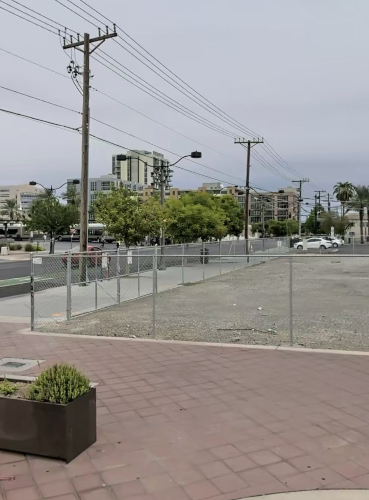 Vacant downtown lot beside a street with utility lines