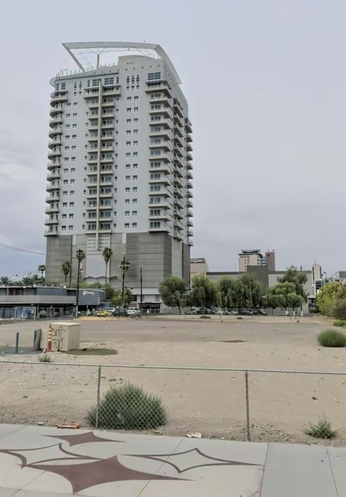 Vacant downtown lot with a tower in the distance